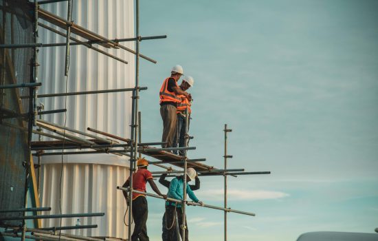 Workers assemble on scaffolding during a construction project outdoors in Maldives.